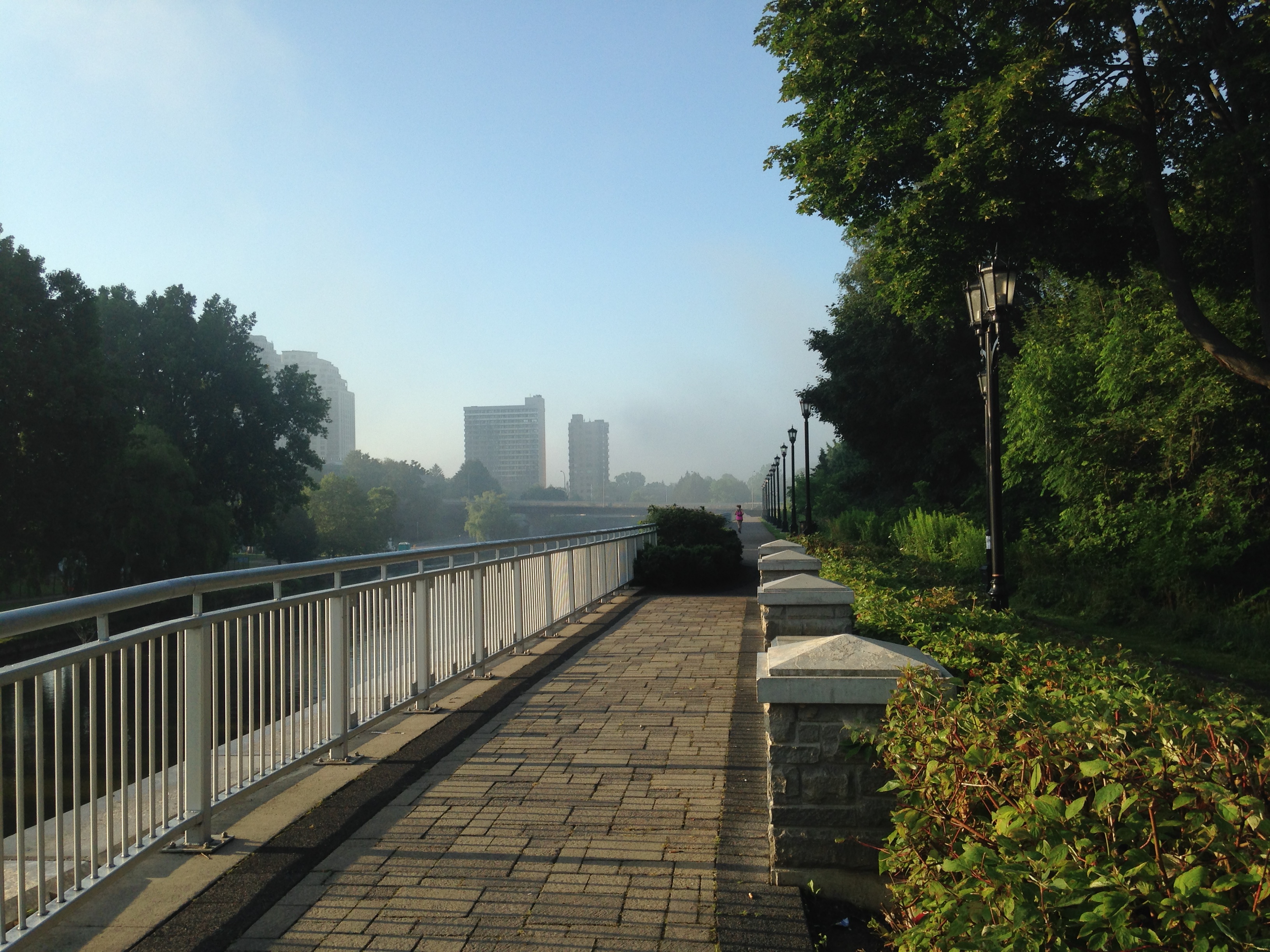 Thames river pathway towards downtown London, Ontario, on a July morning.